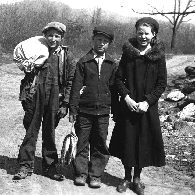 Three Children posing for a photo. 