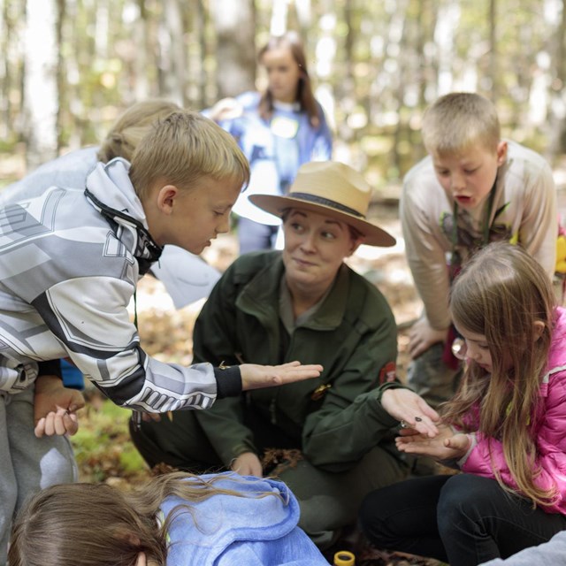 A ranger teaching a group of students.