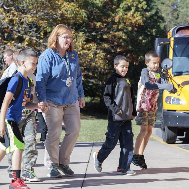 A teacher walking with students.
