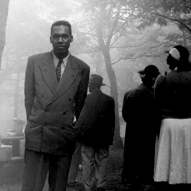 A black and white photograph of a man looking at the camera.