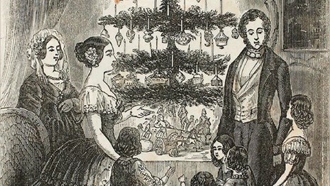 Engraving of a Victorian family next to a Christmas tree