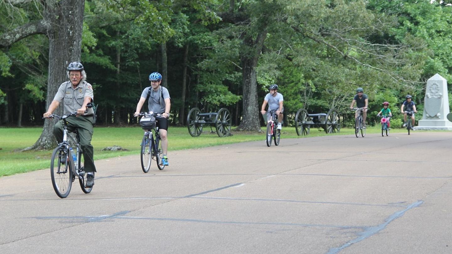 A ranger leading a bike tour. 