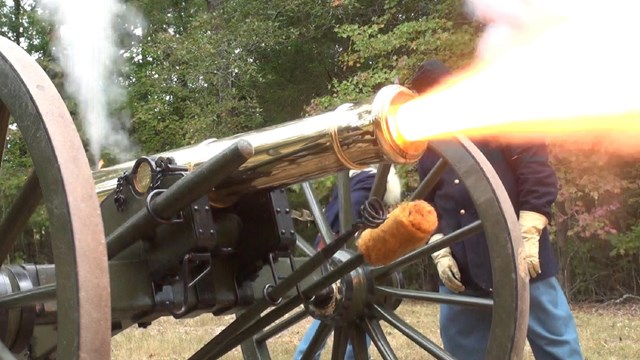 Flames belch from a bronze cannon