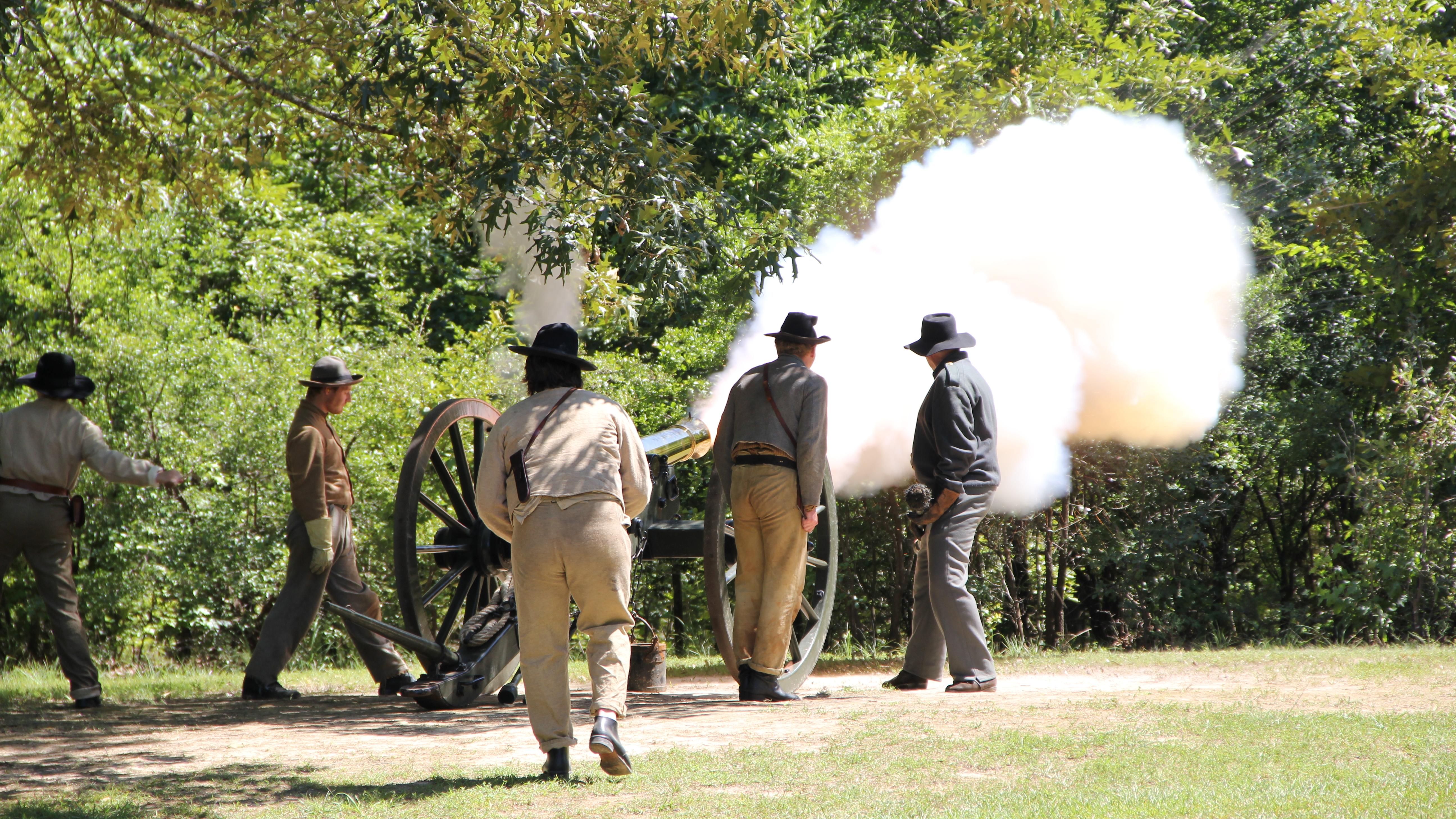 Smoke belches form a bronze cannon. 