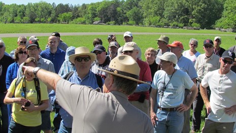 A ranger pointing for a crowd