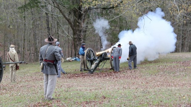Smoke belches as a bronze cannon fires. 