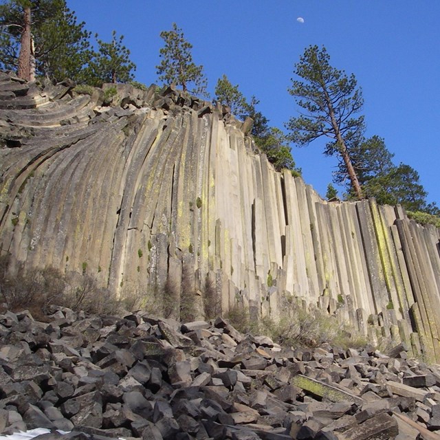 Devils Postpile formation - hexagonal basalt columns forming a 60-foot high cliff face