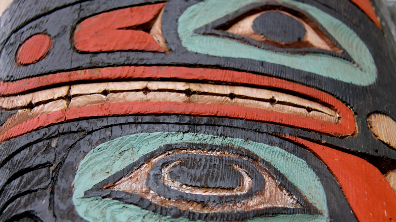 A close up of a totem carving