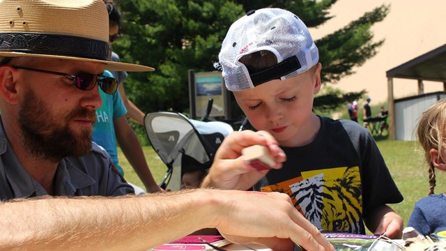 Ranger works on project with young boy