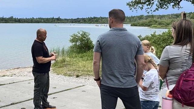 Guest speaker talks to families close to the water.