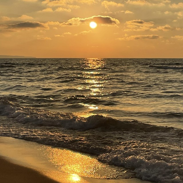 a yellow sunset over a large body of water