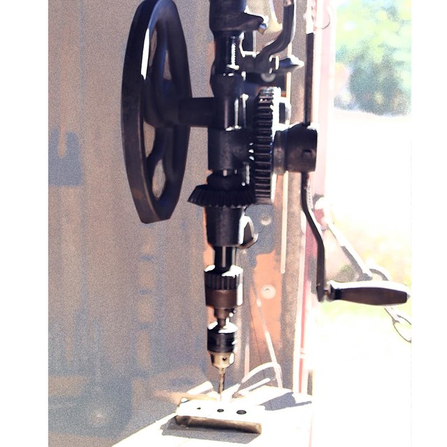 Antique drill press with gears and hand crank