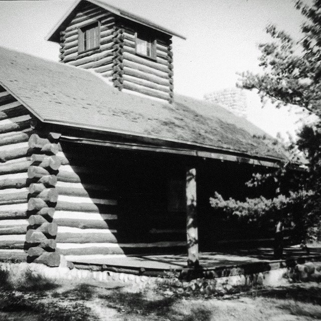 Log cabin with cupola and covered porch