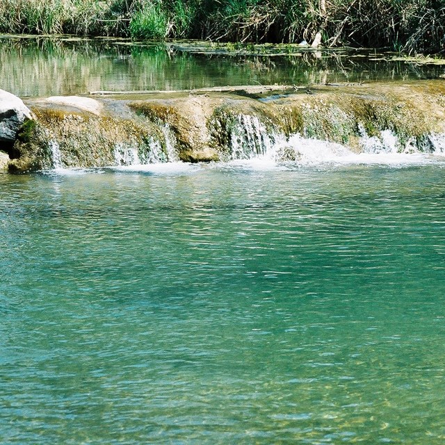 Inviting, turquoise waters of Travertine Creek in Chicksaw National Recreation Area