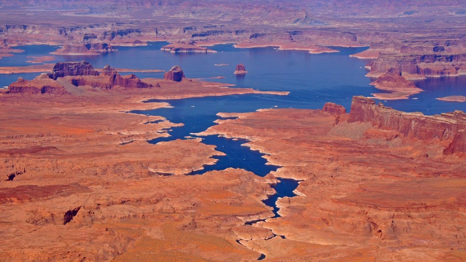 Aerial view of Lake Powell waterways and surrounding red rock buttes and land