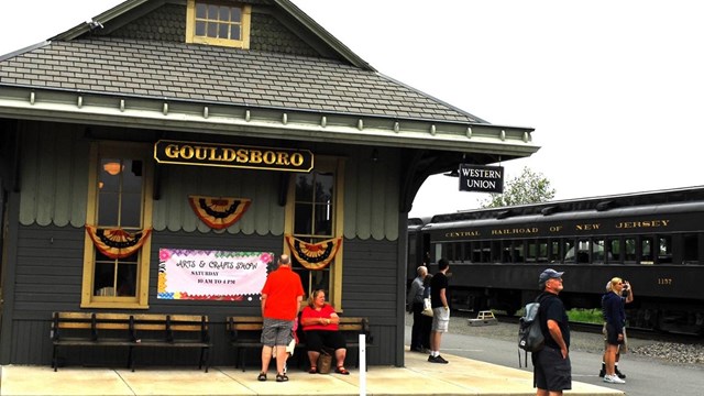 Passenger Coach and passengers outside the Gouldsboro Train Station