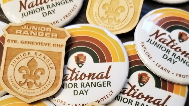 Pile of Ste. Genevieve Junior Ranger Badges and Junior Ranger Day Buttons