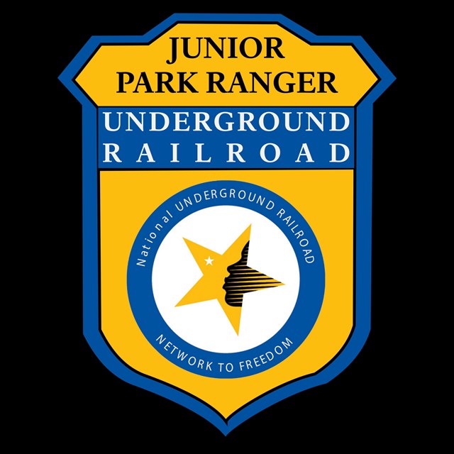 Yellow junior range badge with a star in the center and white text that read undergound railroad.