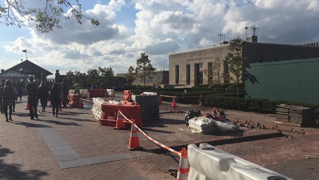 Replacing broken pavers by the Information Center