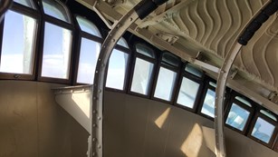 Vertical iron bars with small horizontal windows that make up the design of the crown.