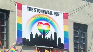 Exterior shot of the Stonewall Inn with a banner saying
