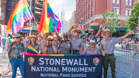 Park rangers participating in a pride parade.