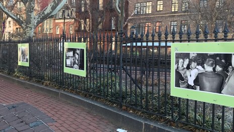 Fence exhibit displaying many historic photos