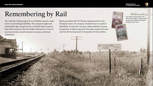 Exhibit with black and white photo of railroad tracks and platform with a sign reading "Cemetery".