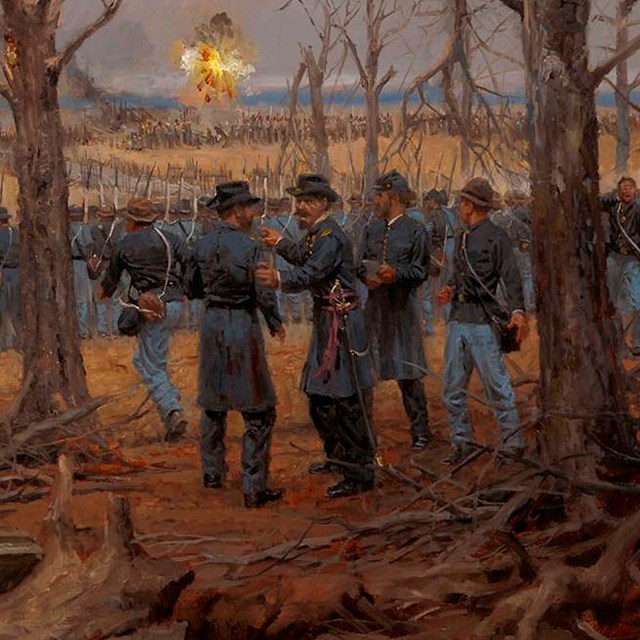 View of a Confederate attack from behind a line of Union soldiers.