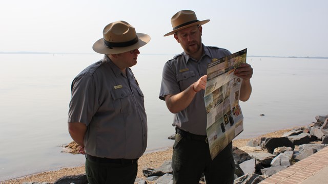 Two Park Rangers looking at the Star-Spangled Banner Trail Map