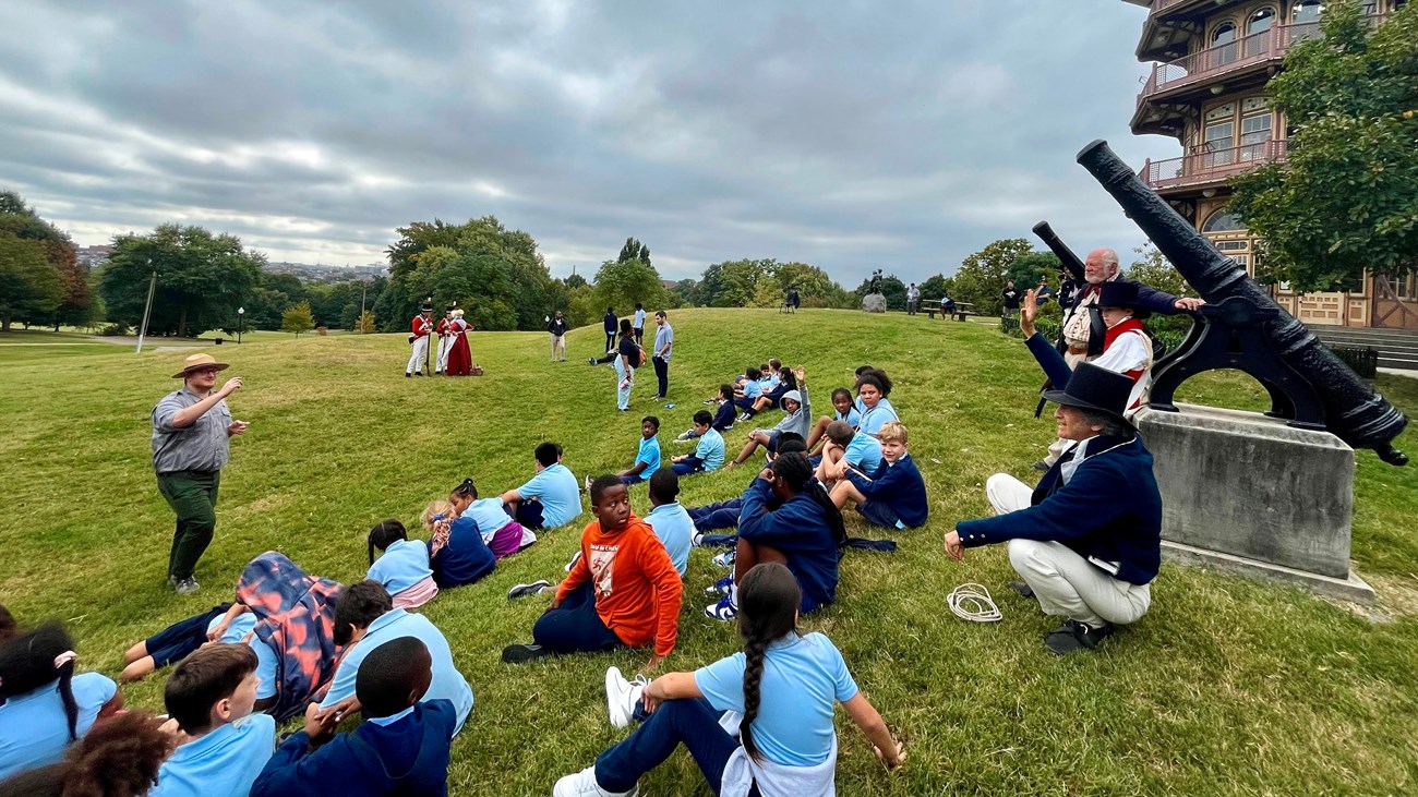 Rangers and living historians talking to people of all ages at Patterson Park