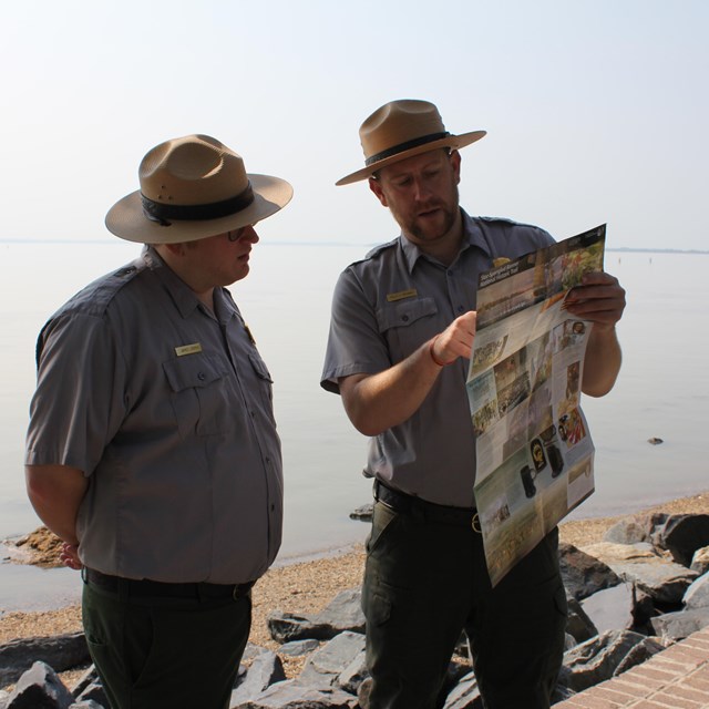 Two Park Rangers looking at the Star-Spangled Banner Trail Map