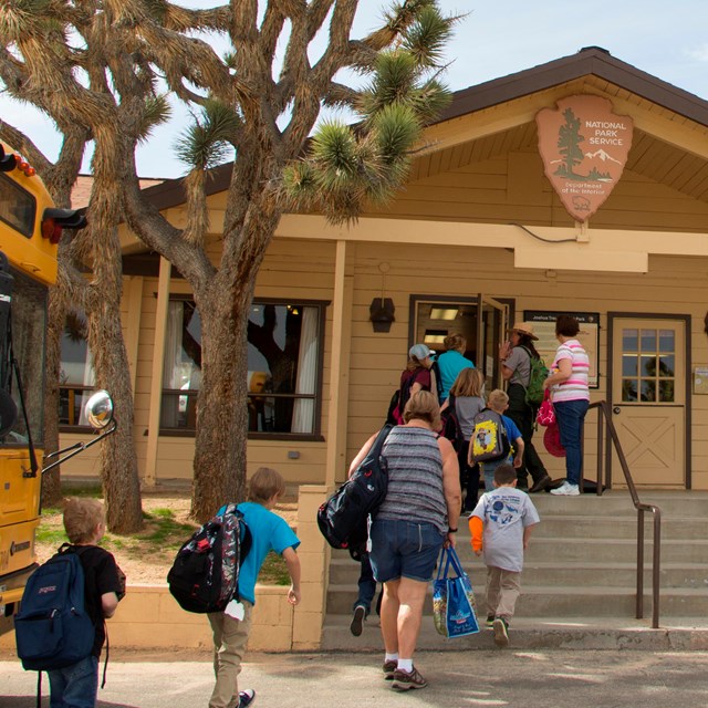 Students leaving school bus to enter Park Classroom