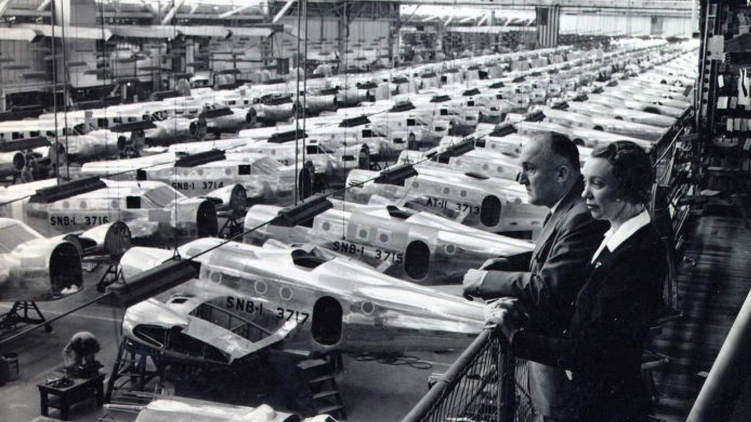 Black and white overhead photo of airplanes lined up in hangar