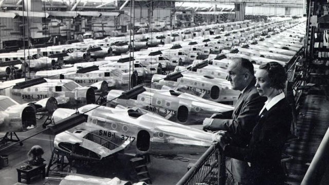 Black and white overhead photo of airplanes lined up in hangar