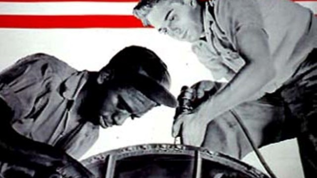 Black and white image of white and Black man working with Color American flag in background.