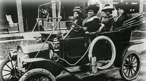 Historic photo of women driving in car.