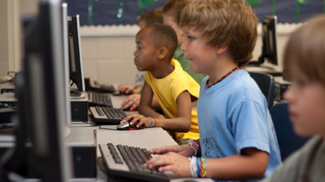 Photo of several children on computers. CC0