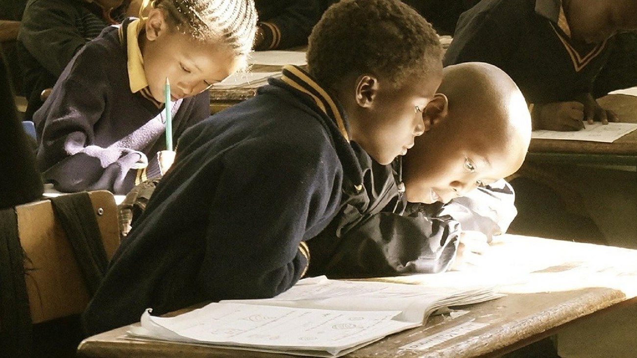 Children looking at a book. 