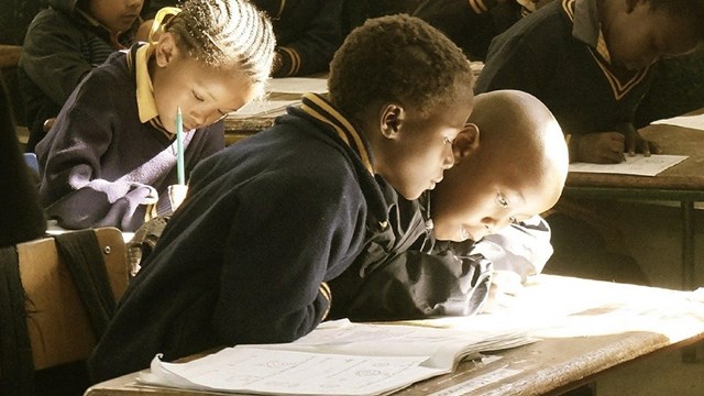 Photo of a classroom and children. 