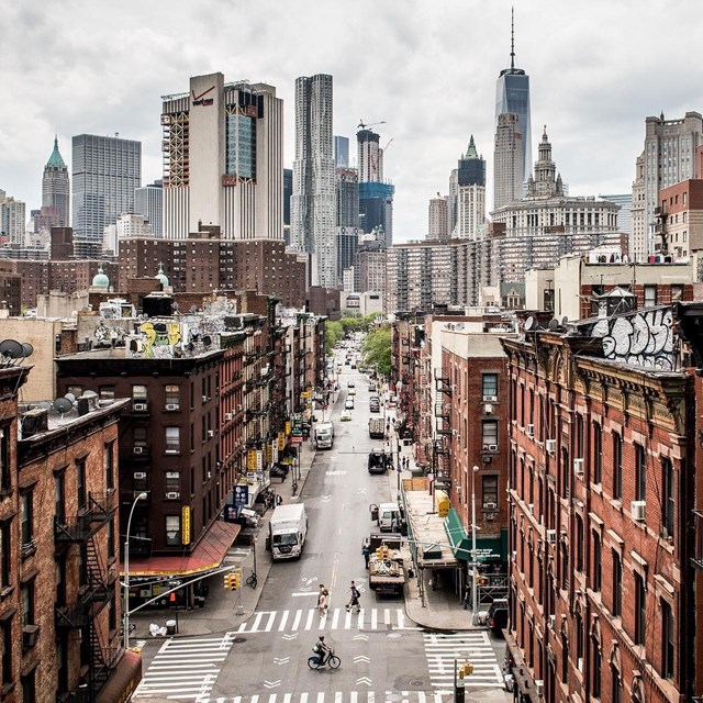 View of a city with tall skyscrapers and historic brick structures. 