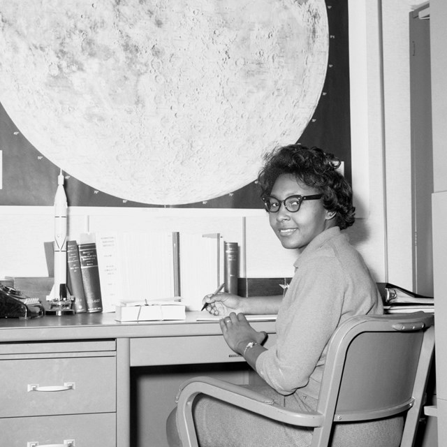 Woman sitting at a desk. 