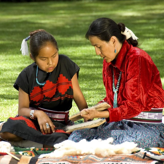 Woman and girl sittign together. 