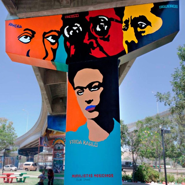 Mural on a highway pillar depicting four famous Mexican muralists