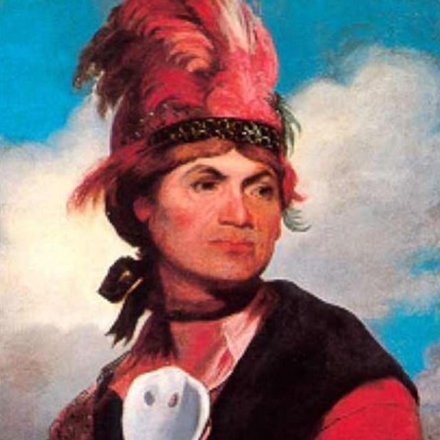 Painting of American Indian in traditional garb. 