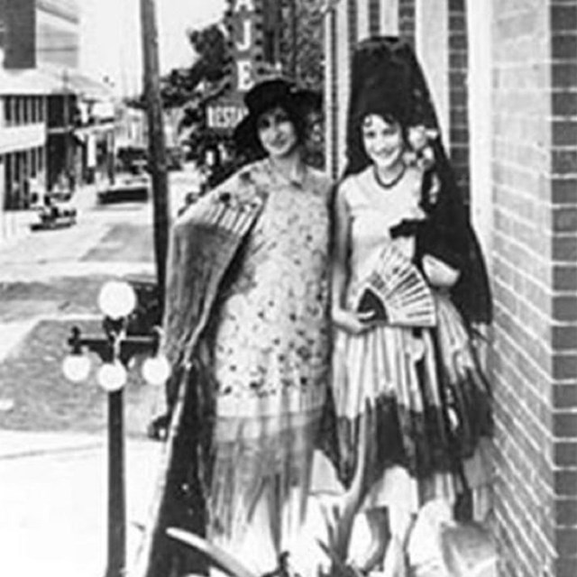 Two women with fans. 