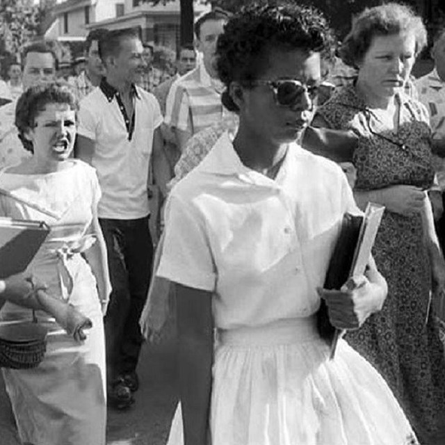 Woman being harassed by a group of people. 