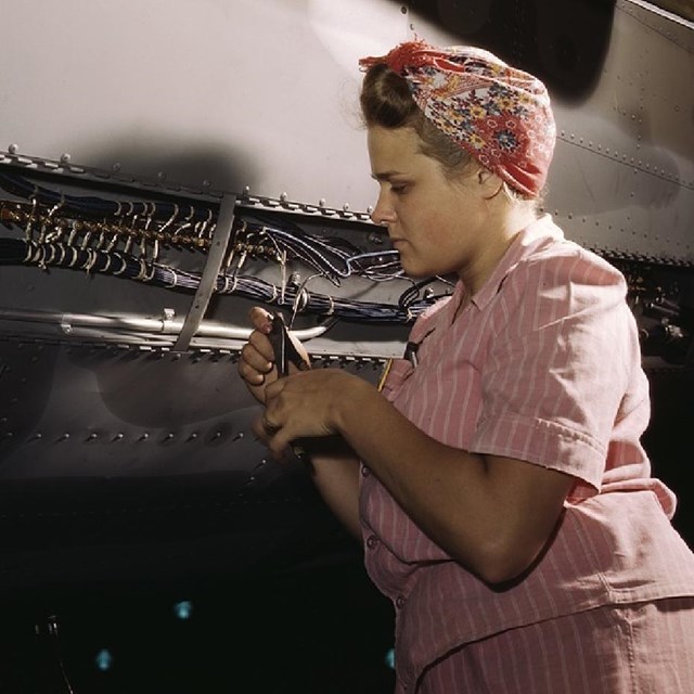 Woman working on a machine. 