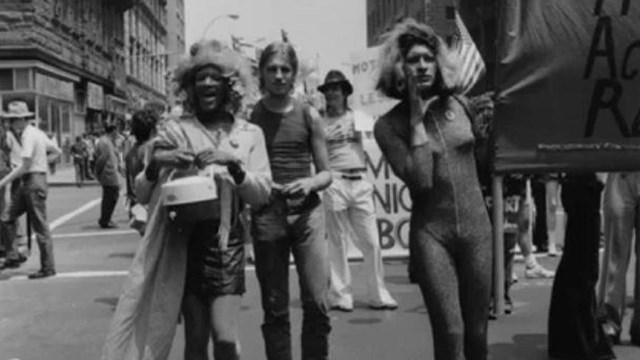 People march through the streets holding a banner