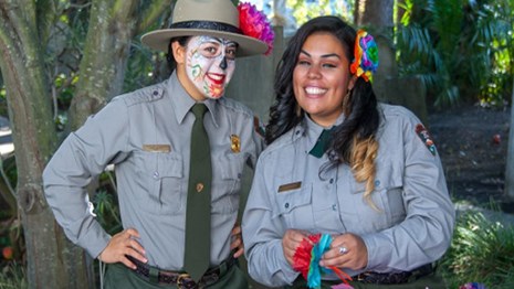 Two park rangers prepare for Dia de los Muertos celebrations